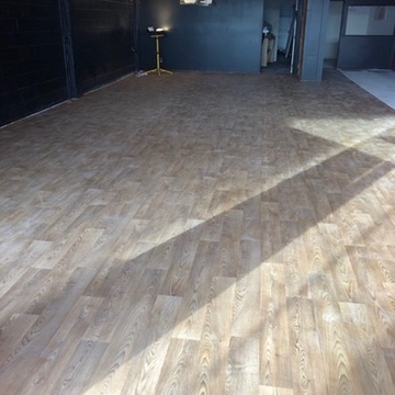 Wide commercial room completed with light timber-look flooring